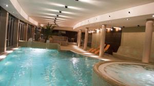 a swimming pool in a hotel with a hot tub at Bilberry Apartman in Balatonfüred