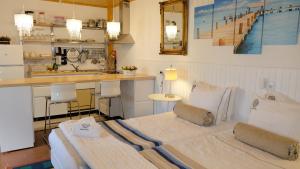a room with a bed and a kitchen with a sink at PH in Atlantic Coast in Charneca