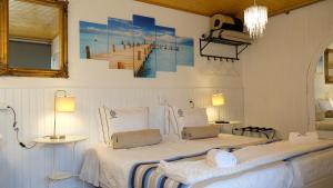 a bedroom with two beds and a painting of a pier at PH in Atlantic Coast in Charneca