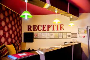 an office with a reception desk with a rescue sign on the wall at Pension Daciana in Bacău