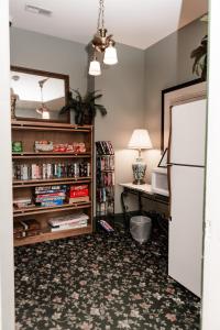 a room with a desk and a white refrigerator at Inn at 835 Boutique Hotel in Springfield