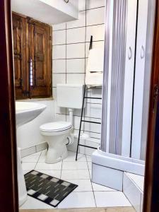 a white bathroom with a toilet and a sink at “La Rampa” Affitti Brevi - Racalmuto (AG) Sicilia in Racalmuto