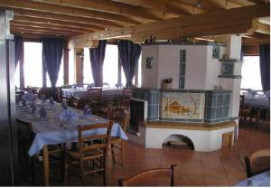 a large dining room with tables and a fireplace at La Vecchia Latteria in Pontebba