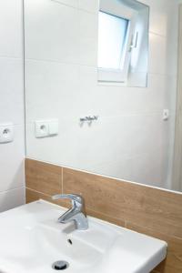 a bathroom with a sink and a mirror at Pomorze Health&Family Resort -Domki całoroczne in Ustka