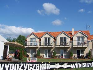 a large house with balconies on a street at Nowe Guty Fun in Nowe Guty