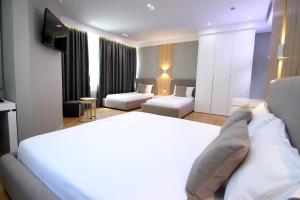 A bed or beds in a room at Hotel One