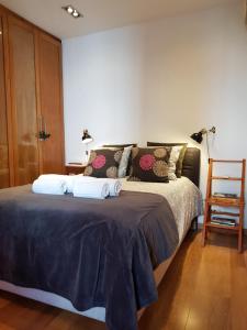 a bedroom with a bed with two towels on it at Casa Da Ponte in Estói