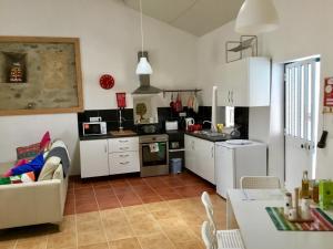 a kitchen with a couch and a table in a room at Pequena Graca in Tomar