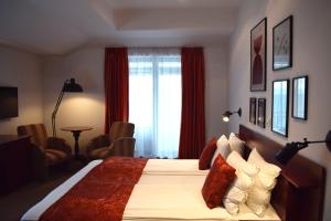 a bedroom with a large bed with red curtains at Villa Dea in Ohrid