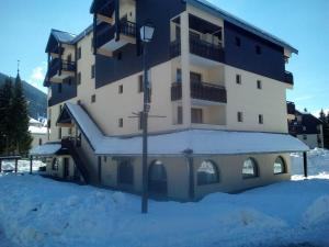 a large building with a lot of snow in front of it at Le Petit Som de Saint Pierre de Chartreuse in Saint-Pierre-de-Chartreuse