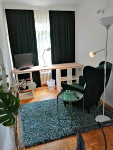 a living room with a chair and a table at Apartment Froschkönig in Gladenbach