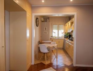 a kitchen with a table and a dining room at La Casa di Adele Cagliari B&B in Cagliari