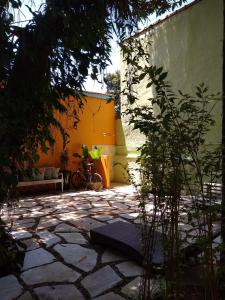 a stone patio with a bike parked next to a building at Suítes Km18praia in Barra do Una