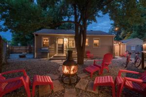 a group of red chairs and a fire pit in front of a house at Italian Style in Old Town with Private Hot Tub in Fort Collins