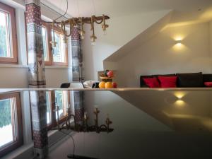 a living room with a couch and some windows at Black Forest Apartements by Hotel Grüner Baum Feldberg in Feldberg