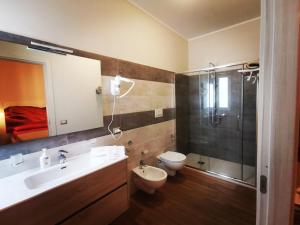 a bathroom with a sink and a toilet and a shower at Il Microcosmo in Marina di Gioiosa Ionica
