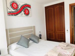 Posteľ alebo postele v izbe v ubytovaní Apartamento Arosa Playa