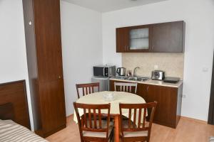 a kitchen with a table and chairs in a room at Iglika 2, V9 in Borovets