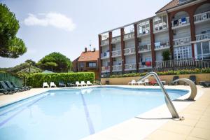 a large swimming pool in front of a hotel at Hotel Torre Cristina in Noja