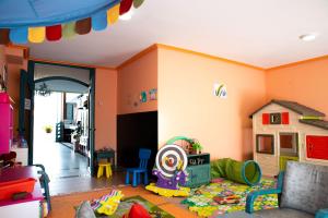 a childs play room with a toy house and toys at Hotel Torre Cristina in Noja