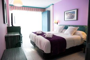 a bedroom with a large bed with two stuffed animals on it at Hotel Torre Cristina in Noja +50 photos