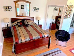 a bedroom with a large bed and a mirror at Micosta Leisure Inn in Hudson