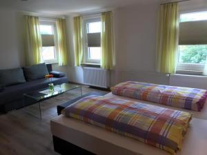 a living room with two beds and a couch at Gasthof Rössle Ochsenwang in Bissingen an der Teck