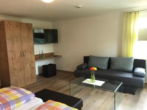 a living room with a couch and a coffee table at Gasthof Rössle Ochsenwang in Bissingen an der Teck
