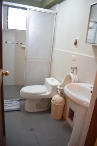 a bathroom with a toilet and a sink at Villas House in Cusco