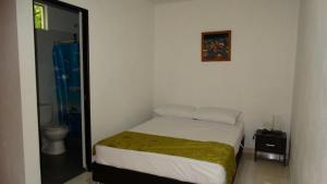 Postel nebo postele na pokoji v ubytování Hotel Campestre El Escape