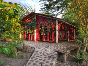 a building with red curtains on the side of it at Hotel Campestre El Escape in Utica