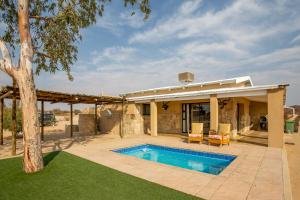 a house with a swimming pool in a yard at Daberas Guest Farm in Augrabies