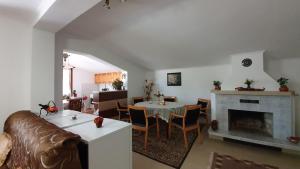 a living room with a couch and a table and a fireplace at Къща за Гости Солакови ** in Devin