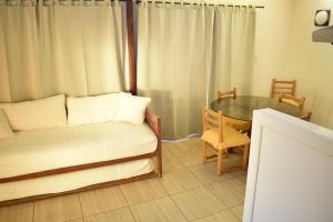 a living room with a couch and a glass table at Apart Hotel Y Cabanas Vegasur in La Serena +43 photos