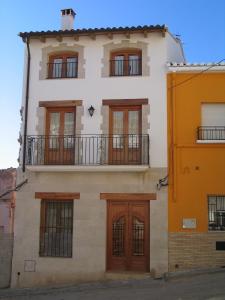 a white building with brown doors and windows at Casa Josefina in Yátova