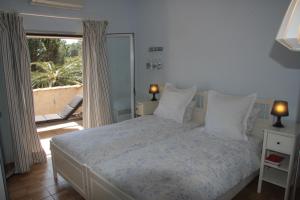 a bedroom with a bed with a view of a patio at Villa Hortense - Golf of Saint Tropez in Sainte-Maxime +32 photos