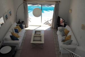 a living room with a couch and a table at Villa Hortense - Golf of Saint Tropez in Sainte-Maxime