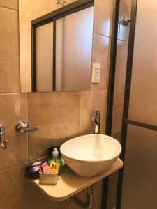 a bathroom with a sink and a mirror at Dúplex Confort in Posadas
