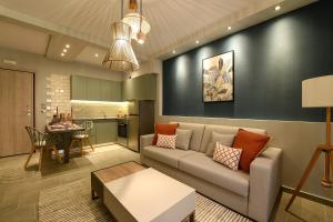 a living room with a couch and a table at Sunny Luxury Suite Grey in Kavála