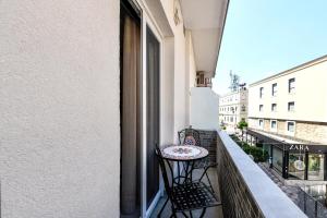 a small table on the balcony of a building at Sunny Luxury Suite Grey in Kavála