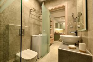 a bathroom with a toilet and a sink at Sunny Luxury Suite Grey in Kavála +15 photos