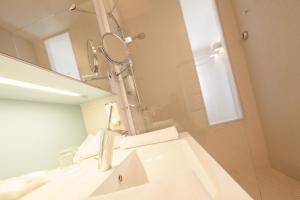 a bathroom with a sink and a mirror at Nymphe Strandhotel & Apartments in Binz