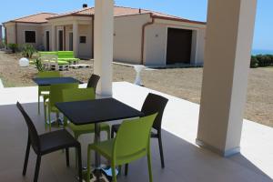 a group of tables and chairs on a patio at B&B L'EDEN DI CAPO BIANCO in Montallegro