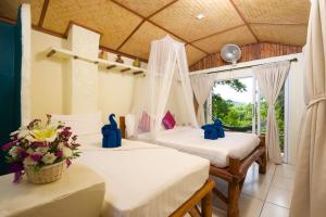 a room with two beds with flowers in it at Bubble Bungalow in Ko Tao
