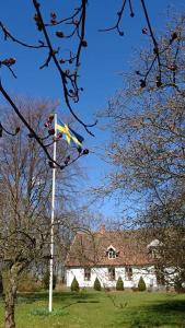 a flag on a pole in front of a building at Bo i Remmarlöv in Eslöv
