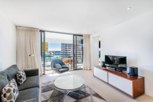 a living room filled with furniture and a tv at Peppers Broadbeach in Gold Coast