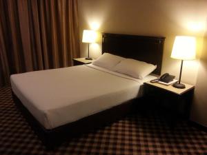 Tempat tidur dalam kamar di Hotel Mimosa