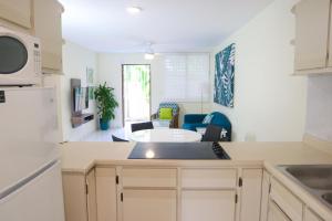 a kitchen with a counter top and a living room at Buena Vida Apartments in Rincon