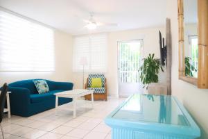 
a living room filled with furniture and a window at Buena Vida Apartments in Rincon

