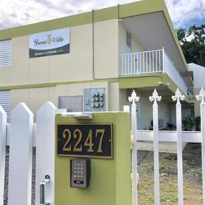 a house with a clock in front of it at Buena Vida Apartments in Rincon